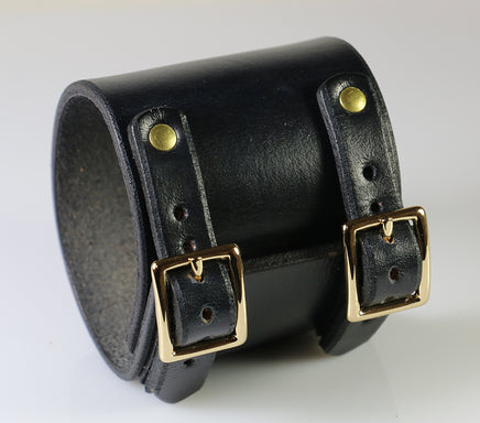 black cuff with gold plated buckle